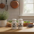 Farmhouse ceramic salt and pepper shaker set on kitchen counter